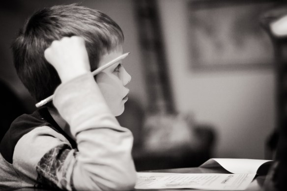 sixth tooth lost this morning. distracted while doing his homework. he's truly growing up. :)